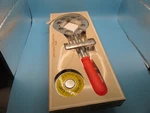 New In The Box Merle Adjustable Corner Clamp With 23 Foot Band 69" Max. Fixed Price $40.00.